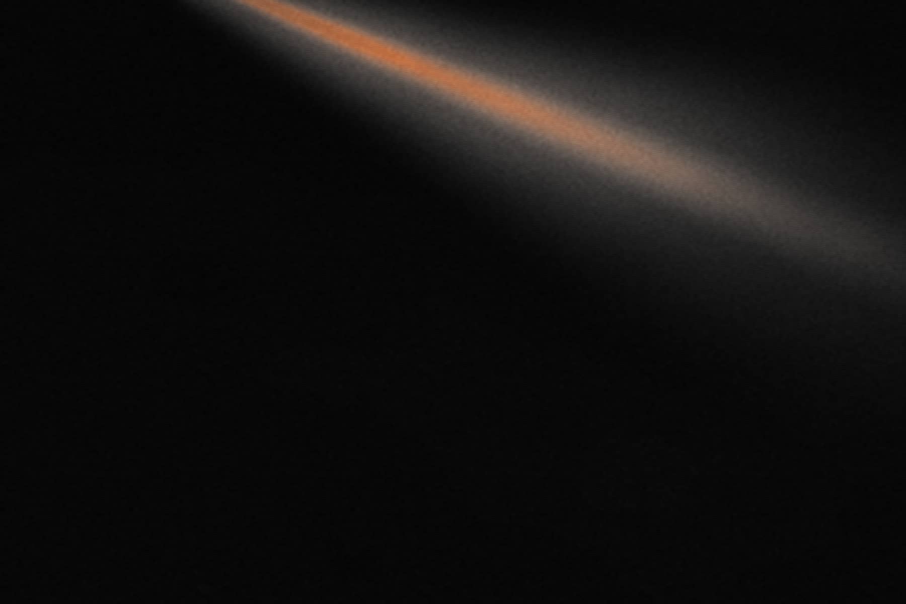 Placeholder live photograph — a dark room lit by a single beam.