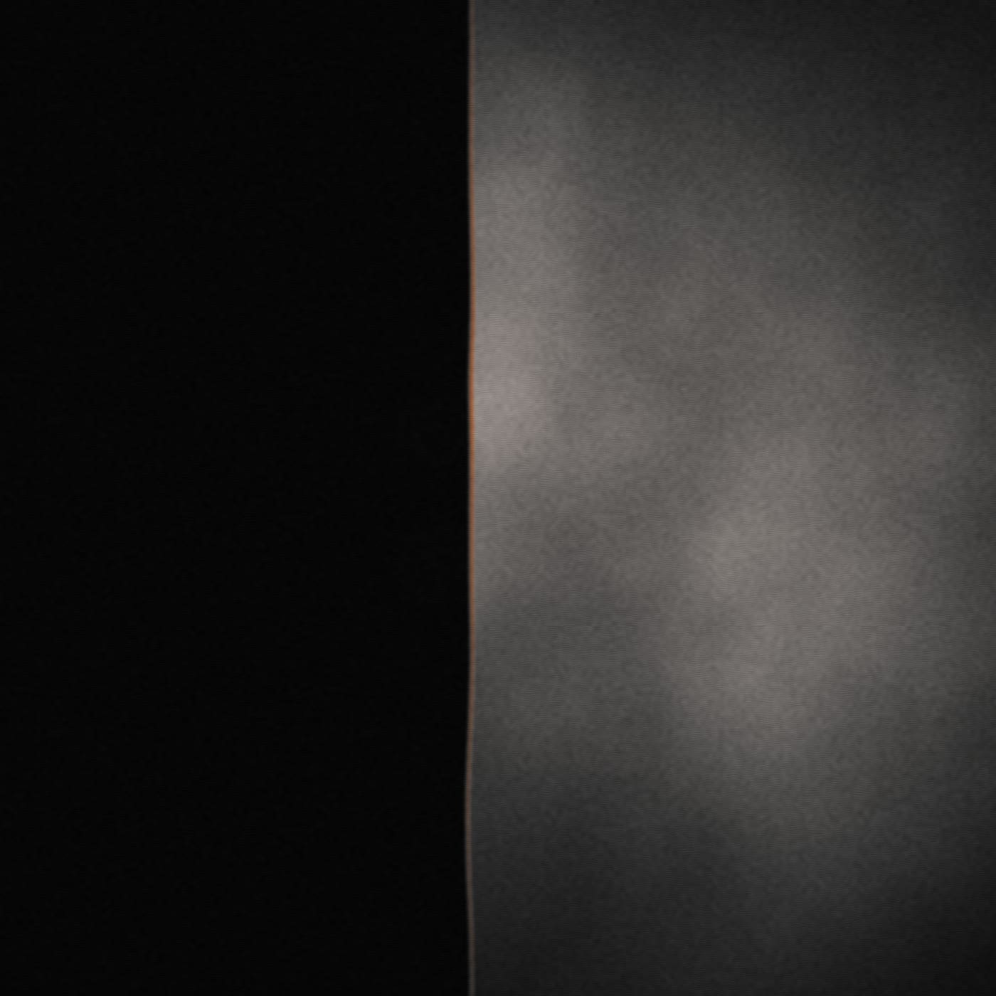 Placeholder photograph — a surface split by a hard edge of light.